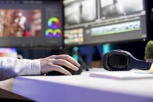 editor polishing raw footage, applying modern editing techniques in order to enhance clarity, sharpness and brightness. Close up of videographer adjusting clips in home office photo