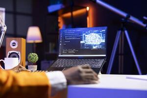 AI professional in home office using laptop to write programming language code. Close up of artificial intelligence engineer working from home using notebook device to build application photo