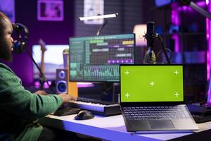 Composer mixing and mastering tracks on professional software, isolated mockup screen. Technician adding sound effects and adjusting volume levels with console, producing new music. photo