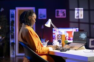 Computer scientist updating artificial intelligence neural networks, writing binary code scripts. Remote worker in apartment office uses digital device programming to upgrade AI photo