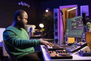 Modern producer playing piano keys to record a new soundtrack, trying to produce a song using midi controller electronic keyboard. Songwriter composer playing instrument notes to create tunes. photo