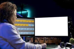 Photo editor using isolated screen monitor to color correct photographs in creative studio. Photographer selecting best pictures for editorial content with mockup desktop computer