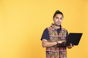 Portrait of smiling man using laptop to do business related tasks for company, isolated over studio background. Upbeat employee doing budgeting, forecasting, and financial analysis on notebook photo