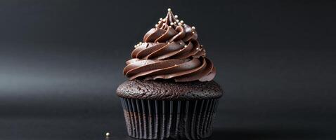 A chocolate cupcake with a frosting topping photo