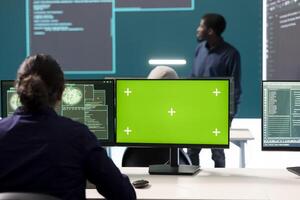 Hackers team working with a green screen layout on computer in monitoring room government center, high tech. Skilled specialists studying data for cyber warfare tactics, national security. photo