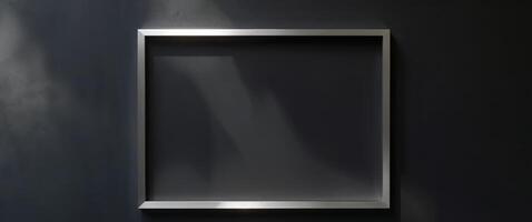 A black wall with a square frame on it photo