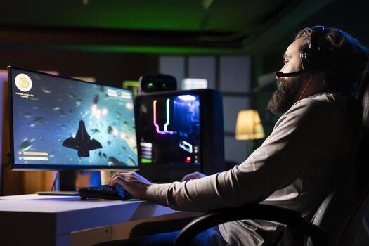 Man wearing headphones shooting asteroids in spaceship flying game with overlay HUD showing health, fuel, and ammo bars. Gamer navigating universe in simulation game, chatting with friends on mic photo