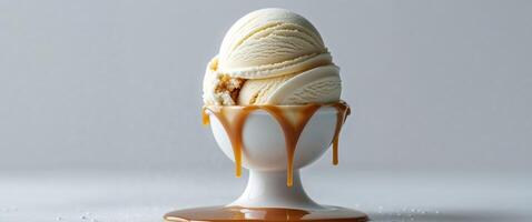 Caramel swirl ice cream scoop with a drizzle of caramel photo