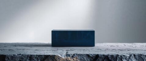 Dark blue rectangular object on stone surface. photo