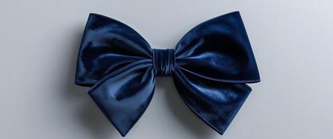 Luxurious navy blue velvet bow with impeccable folds and a silky texture perfect for adding elegance to any project. photo