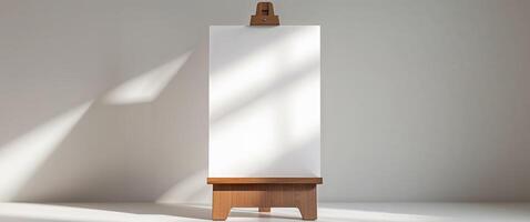 A white easel with a wooden stand in front of a window photo