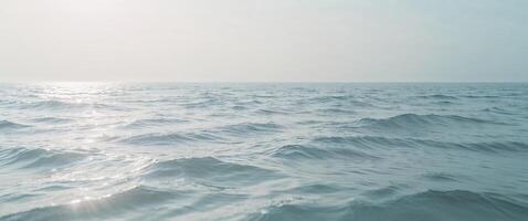 A view of the ocean with waves and sun photo
