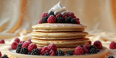A stack of pancakes with berries and whipped cream photo