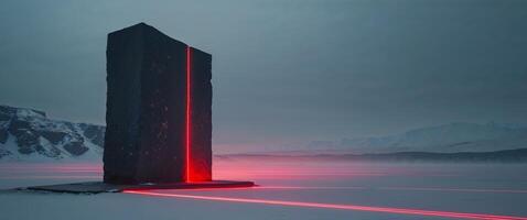 A tall black pillar in the middle of a snowy field photo