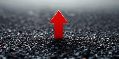 A red arrow pointing up in the middle of a black background photo