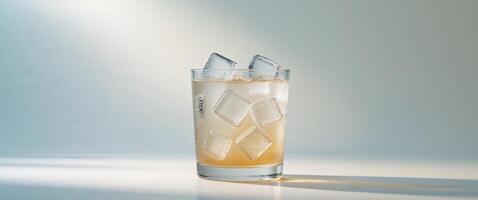 Refreshing Glass of Iced Beverage with Ice Cubes and Shadow photo
