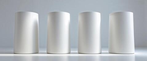 Three White Cylindrical Display Stands in a Studio Setting. photo