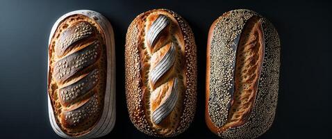 Three Different Kinds Of Baked Bread Loaves On Black Background Overhead View Offering Texture And Various Forms And Seeded Crust photo