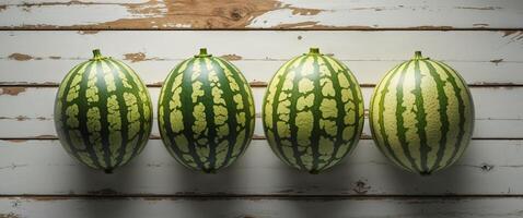 Four Fresh Watermelons Lined Up on Rustic Wooden Table Background photo