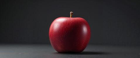 Red Apple with Unique Butt Shape on Black Background Still Life. photo