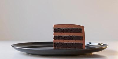 Decadent Chocolate Layer Cake Slice on Black Plate photo