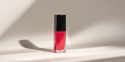 A red liquid lipstick sitting on a white surface photo