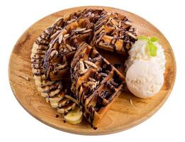 Homemade waffle with ice cream and chocolate sauce isolated on a white background. photo