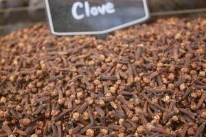 Clove spices displayed for sale at a marketplace stand photo