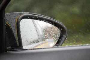 Rainy day view from a car side mirror in a tranquil setting photo