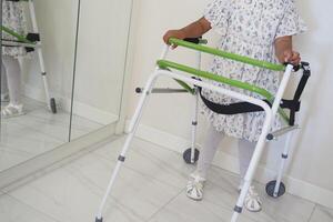 Child using a walker in a bright indoor space photo