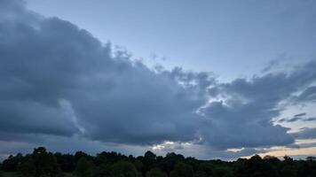 A dark sky with clouds over a field video
