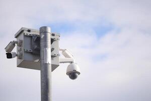 Security camera setup monitoring urban environment on clear day photo
