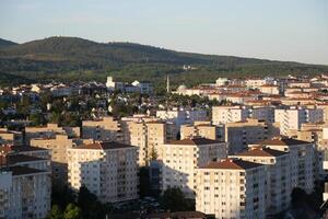 Cityscape view of residential buildings and mountains in daylight photo