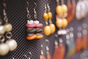 Colorful handmade earrings displayed at a local artisan market photo