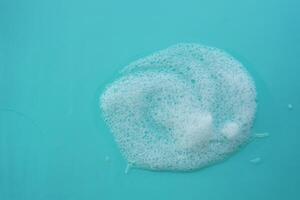 Bubbles forming on a turquoise surface in a clean environment photo