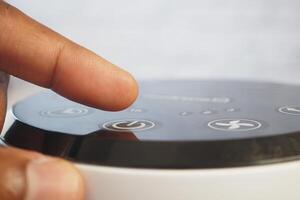 Adjusting settings on a modern device at home during the day photo