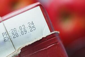 Red packaging with date markings in a grocery setting photo