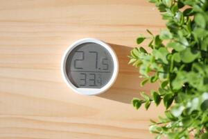 Digital thermometer displays temperature in a cozy indoor setting photo