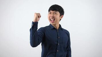 Asian man feeling very happy show fist up for success emotion,Businessman in slowmotion happy and cheerful on white background video