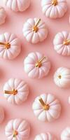 Elegant mini pumpkins with gold stems on soft pink background. Perfect for autumn decor photo