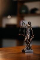 Golden lady justice statue is displayed on a wooden desk in a lawyer office. consulting a business client in a modern office. Concept of professional legal services for businesses photo