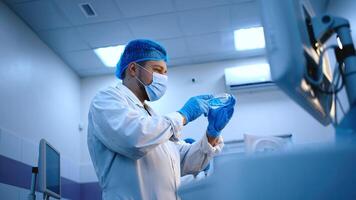 Caucasian Male Scientist Working with Samples, Using Micro Pipette for Mixing Chemicals and Acids. Advanced Scientific Specialist Working with Modern Digital Microscope. Blue background, advertising photo