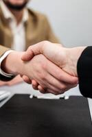 Businessmen signing documents, handling deals and contracts. Concept legal formalities, bank loans, insurance purchases, and will preparation in the office. Handshake. Vertical shot photo