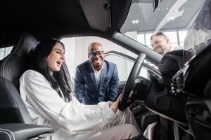 Dynamic interaction showcasing a car dealership effective communication and sales skills in promoting vehicle features to potential clients in a bright and inviting showroom photo