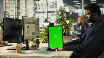 Close up of isolated screen tablet used by worker in office reviewing financial graphs. Employee looking over data trends and strategic insights on mockup tablet, analyzing KPIs, camera B video