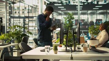 Employee arriving in office, looking over revenue figures on documents. Accountant in office starting job shift, comparing company statistical numbers, working hard to finish tasks before deadline video