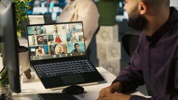Employee having online discussion with coworkers in call meeting, working from office. Staff member in conference over the internet with teleworking colleagues, camera A video