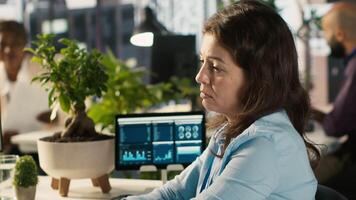 Stressed worker in office sighs, burdened by too many documents to review. Tired employee at work feeling overworked while analyzing business performance metrics, camera A video
