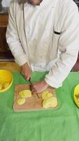 Home chef cuts Potatoes To Make Them Fried On The Table Vertical video