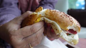 Enjoying a savory sandwich at a local cafe in the afternoon video